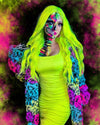 Woman wearing SpiritHoods Neon Graffiti Leopard Collector Edition Coat with bright neon green hair and colorful skull body art against a multicolored background. Halloween Costume Inspiration, Halloween Outfits
