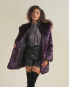 Curly haired female model wearing midnight wolf fake fur jacket and holding the right side of the coat open to show black liner.