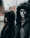 SpiritHoods Men's Black Wolf Hooded Fake Fur Jacket with the model wearing a silver mirror face mask, halloween costume inspiration, easy costume ideas with SpiritHoods coats