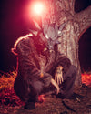 A Man wearing a 3-dimensional wolf mask in the forest, bent down in front of a tree, wearing SpiritHoods Best Selling Men's Classic Grey Wolf Fake Fur Jacket. Easy Halloween Costumes for Men. halloween costumes and halloween party outfits.