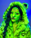 A Woman smiling at the camera, wearing SpiritHoods Neon Green Fake Fur Jacket with a hood and ears, with neon green leopard print face paint against a blue background. Lisa Frank Halloween Costume. Animal inspired halloween outfit ideas.