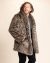 Man wearing a faux fur coat against a plain background