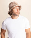 Man wearing a leopard print patterned bucket hat against a plain background