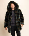 Man wearing a brown, black and green 100% fake fur raver coat with a hood on a beige background
