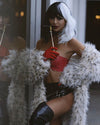 A Woman seductively looking at the camera with one leg up, dressed as cruella deville, wearing SpiritHoods Classic Baby Snow Leopard Long Fake Fur Coat. Easy Halloween Costume Ideas for Women. Halloween Outfits,