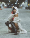 A Woman in SpiritHoods White Long Fake Fur Jacket with Leopard Print bent down, dressed as cruella deville for Halloween. Easy Halloween Outfits and Halloween Costumes for Women.