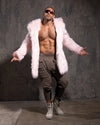 Man wearing SpiritHoods Pink Faux Fur Coat in Flamingo Wolf with the hood down, against a textured gray wall