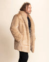 Man smiling, looking forward, with his hand in the outer side pocket of SpiritHoods Beige Faux Fur Coat. Peta Approved Vegan Fashion Brand, Collector Edition Cougar Fake Fur Jacket for Men