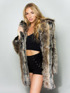 Grey Wolf vegan coat worn by blonde girl with the hood down while holding her lapel and looking directly at camera.