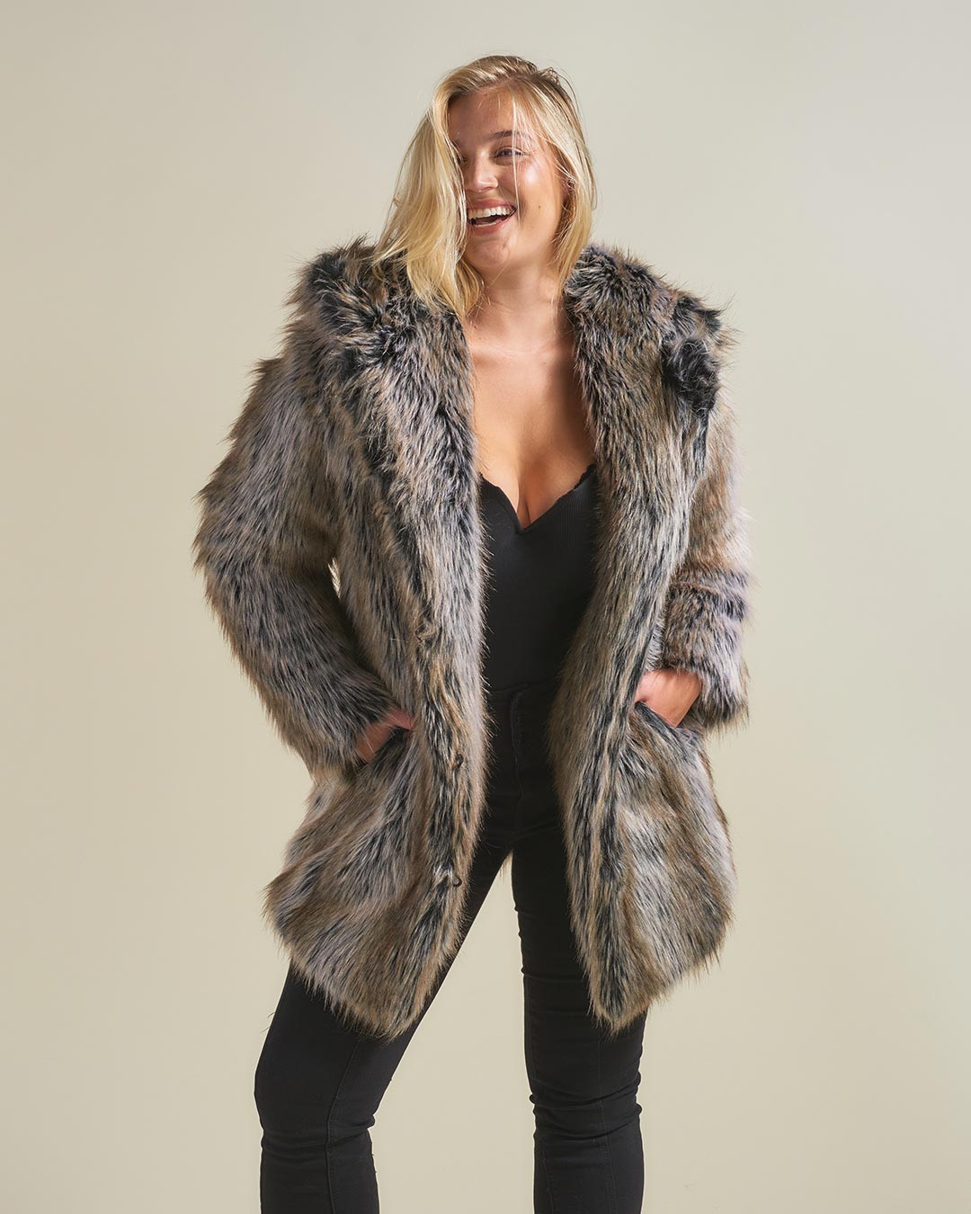 Blonde woman wearing Grey Wolf Classic Faux Fur Coat by SpiritHoods. Her hands are in her pocket.