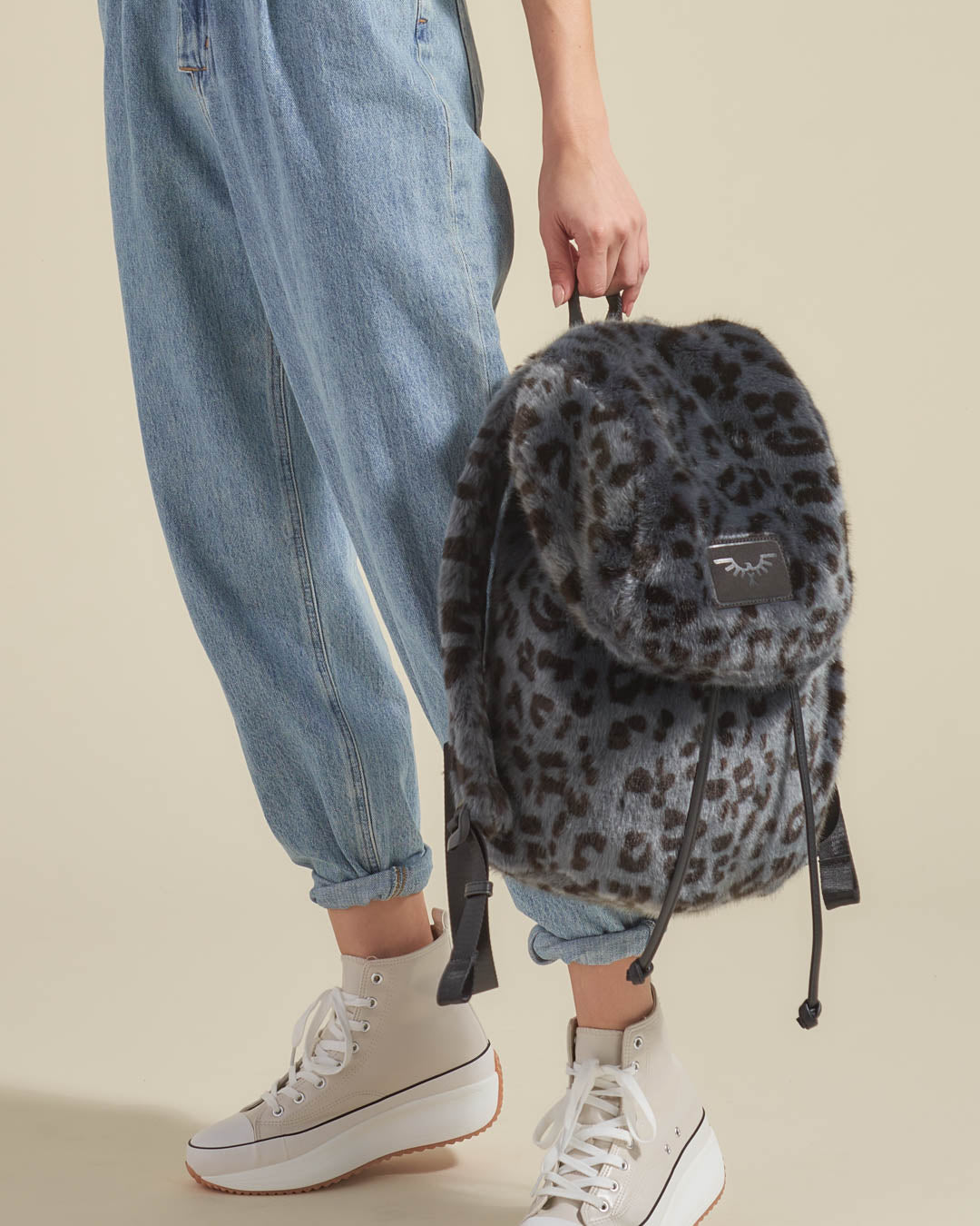 Woman Holding Slate Grey Leopard Faux Fur Backpack