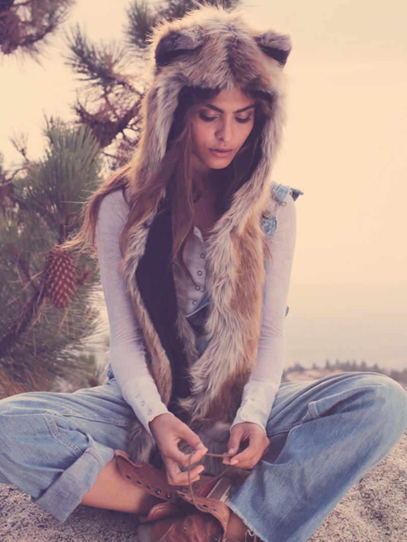 Woman Sitting Outside on a Rock While Wearing Red Fox Faux Fur Hood