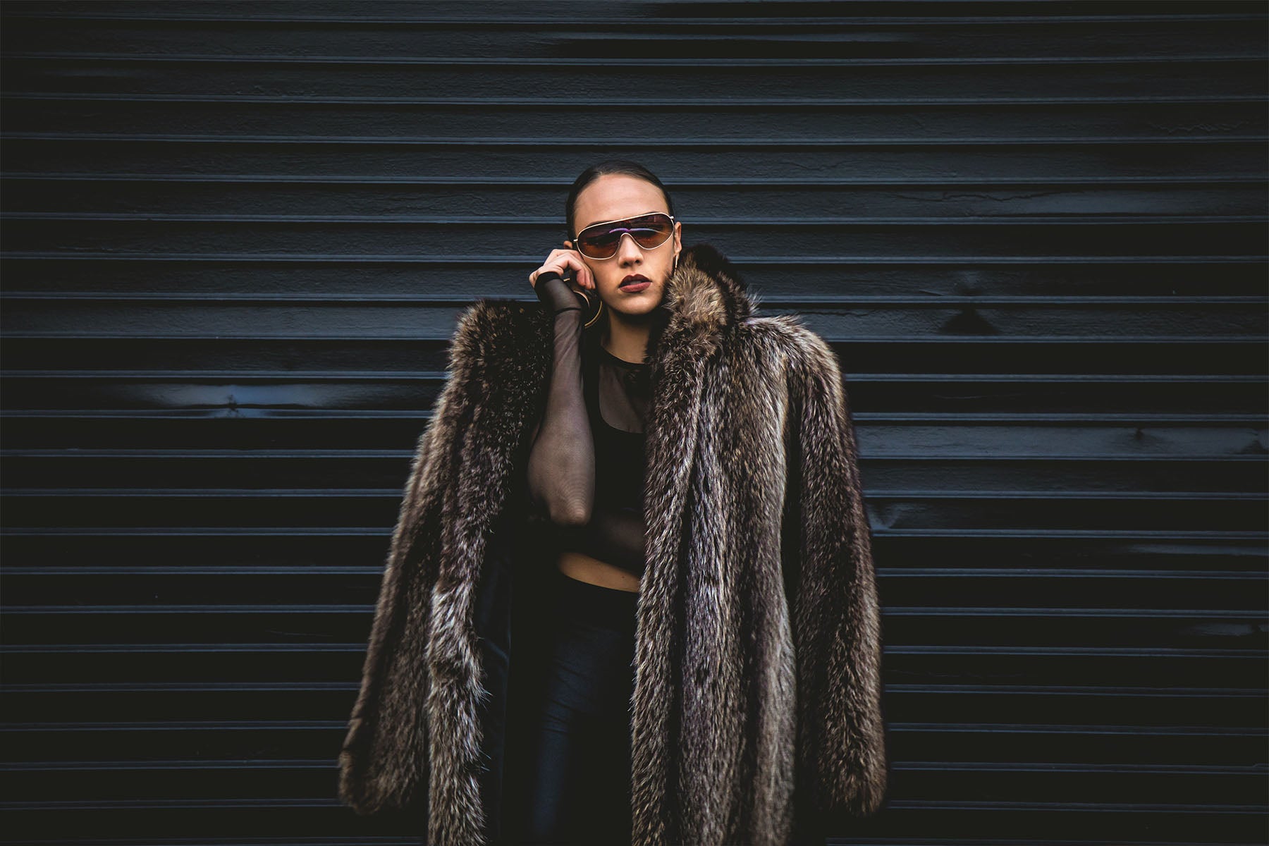woman wearing faux fur coat and sunglasses