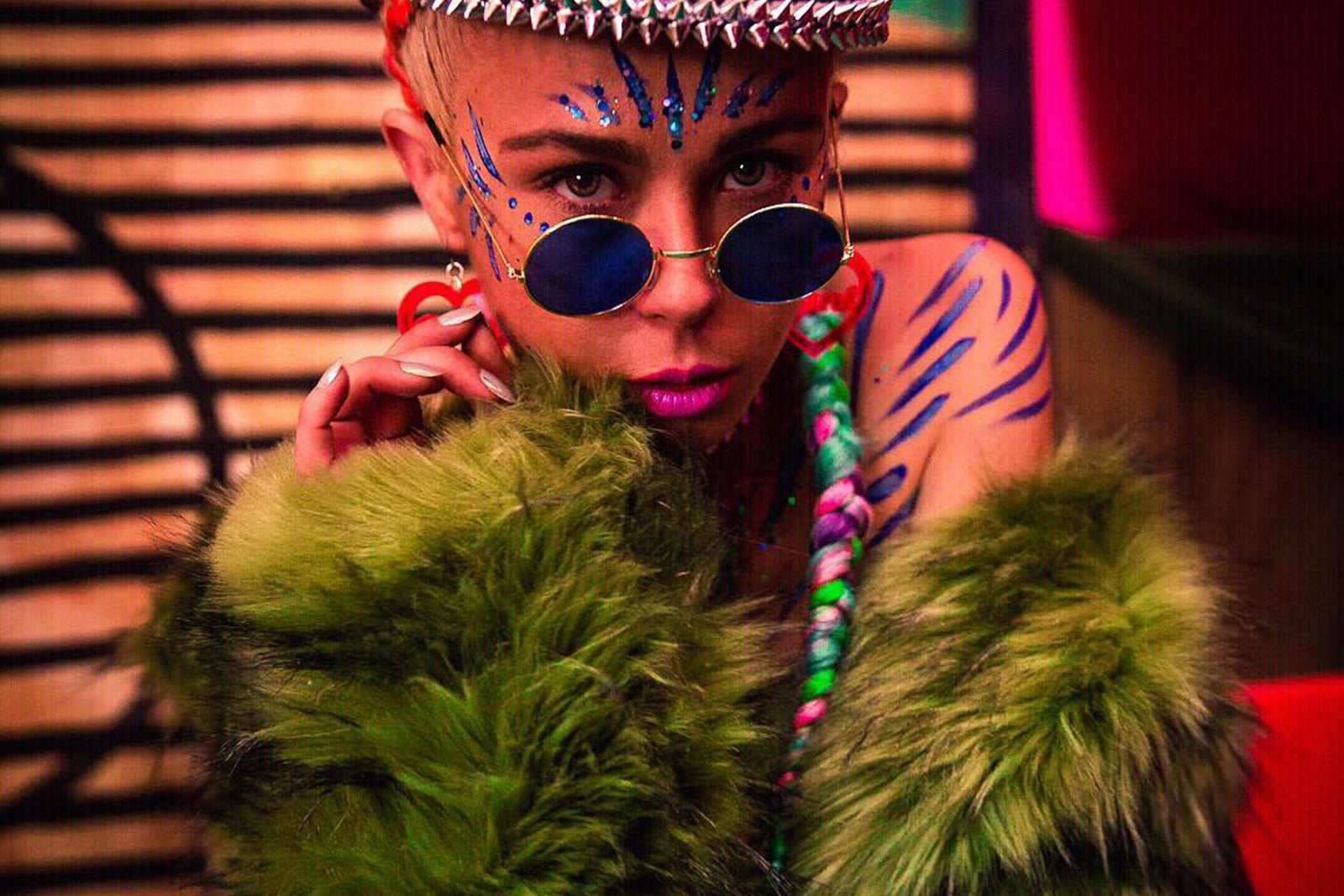 person wearing sunglasses lower on face and faux fur