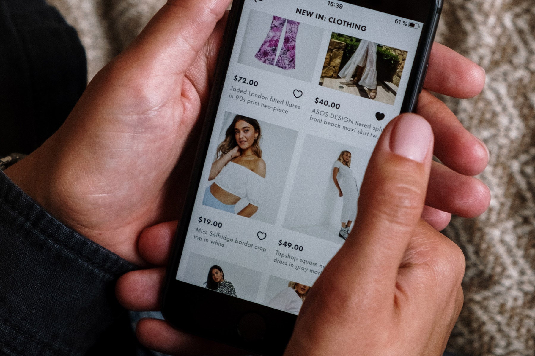person holding smartphone and shopping online