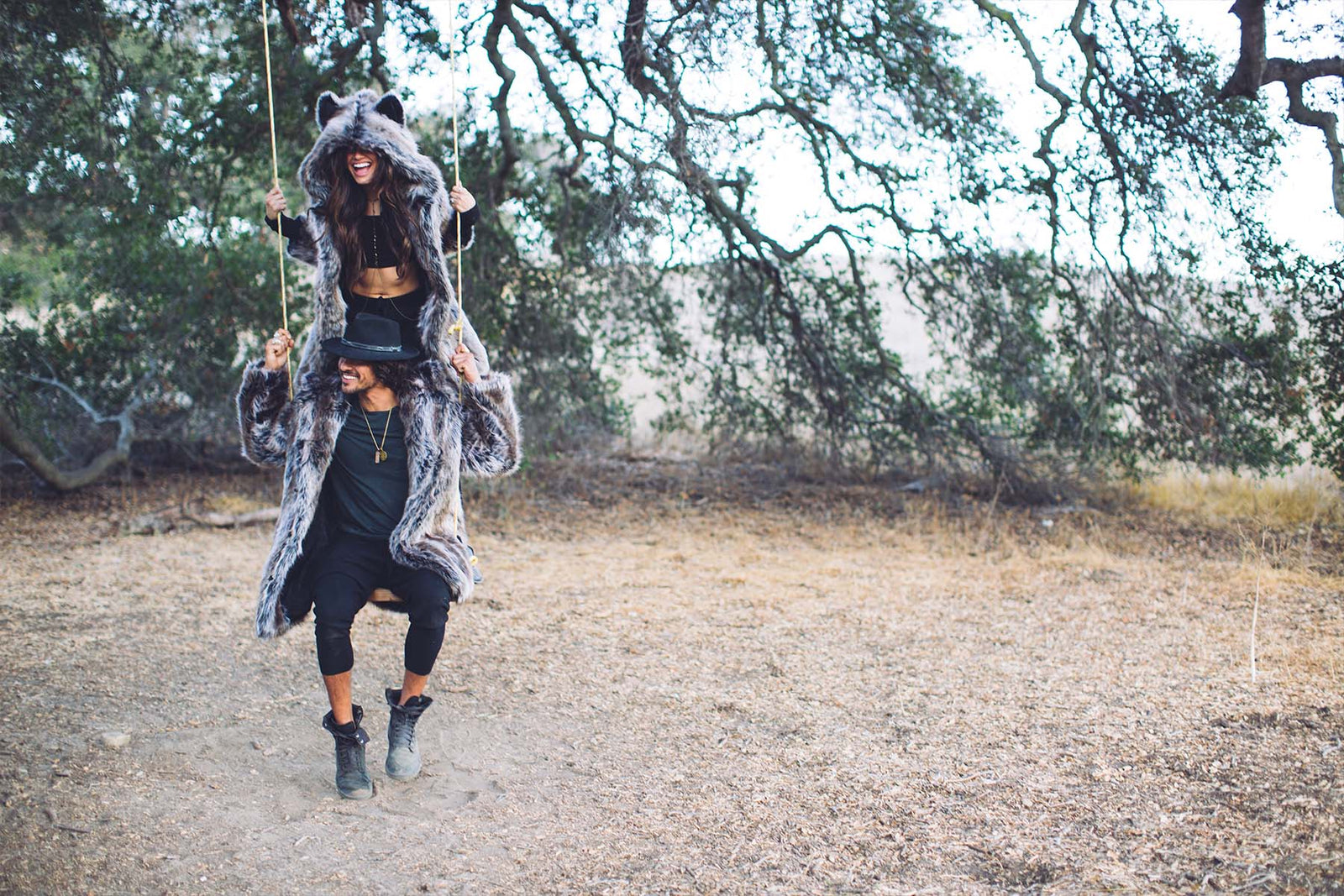 people on each others shoulders wearing faux fur