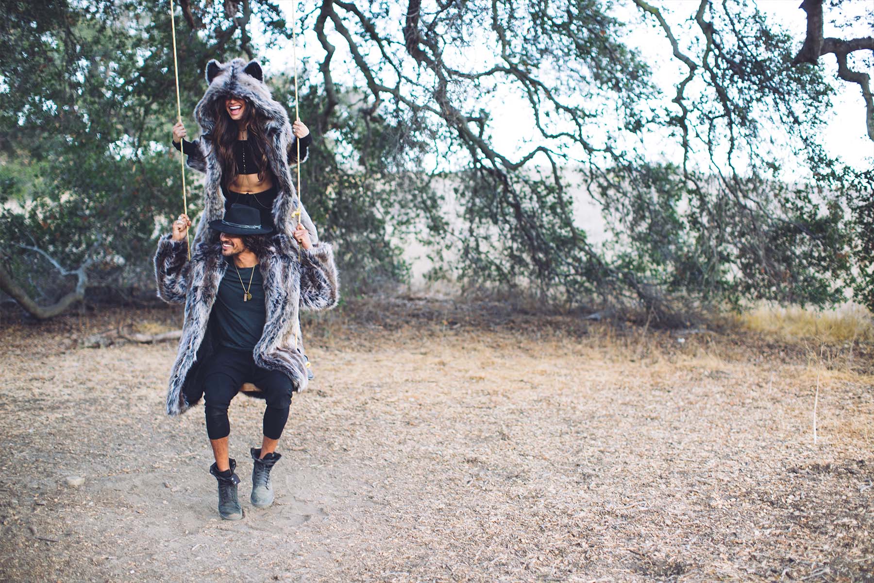 people on each others shoulders wearing faux fur