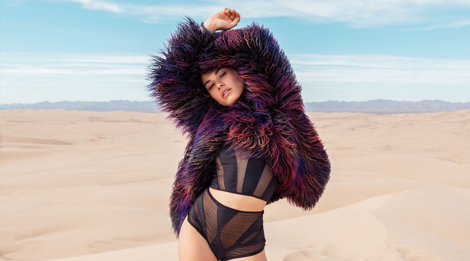 girl in black and sheer bikini with faux fur coat on