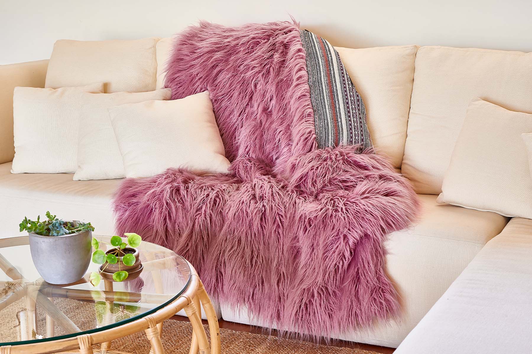 faux fur pink throw on creme couch