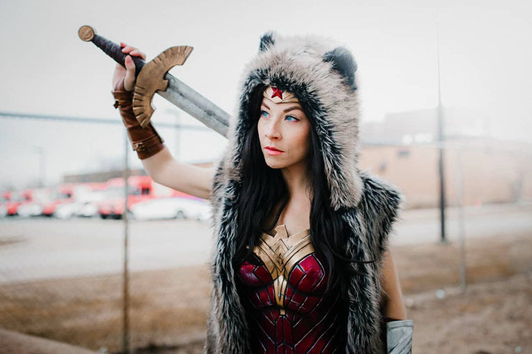 woman in wonder woman costume with faux fur hood on