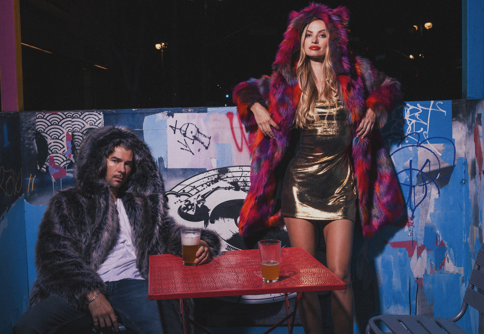 A man and a woman wearing SpiritHoods faux fur coats. 