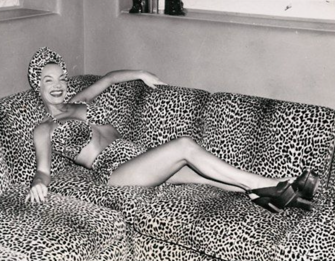A black and white image of Carmen Miranda in a leopard print bikini.