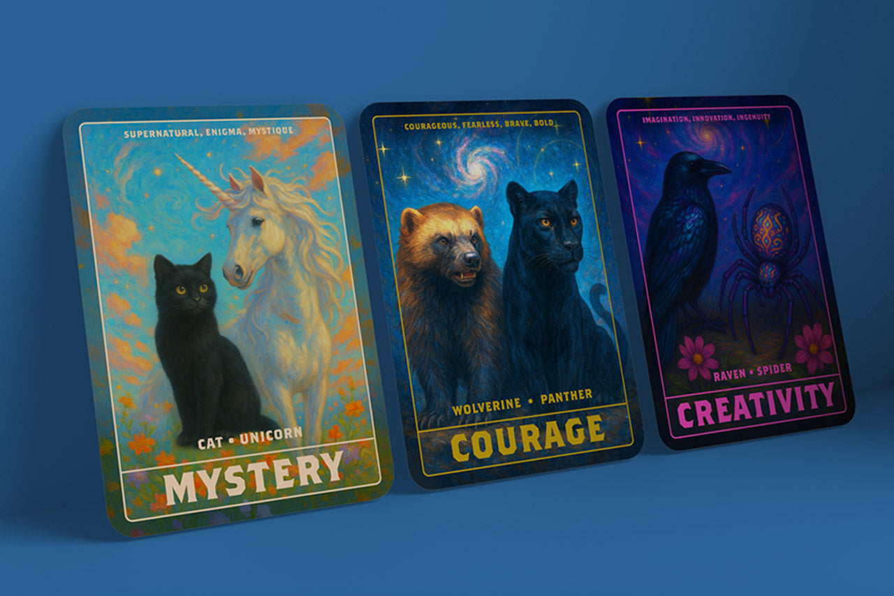 Three cards with similar style to tarot cards, each showing two animals that represent specific traits. The 3 cards are; MYSTERY, COURAGE, CREATIVITY.