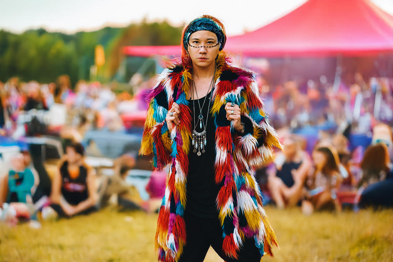 An image of a man wearing the SpiritHoods butterfly faux fur coat at a music festival.