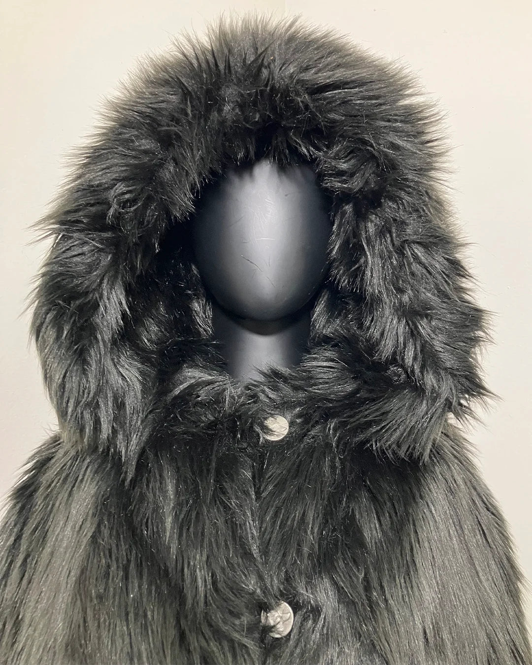 close-up photo of the mannequin with the Hood Up show casing the plush long pile black fake fur and wolf-face buttons. SpiritHoods Online Sample Sale Style: Hooded Faux Fur Coat in Black Wolf size X-SMALL.