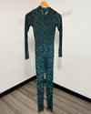 A long-sleeve full-length jumpsuit with a black and teal-green leopard print pattern, hanging on a wooden hanger against a white wall.