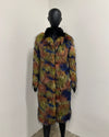 Multicolored fur coat on a mannequin against a white wall