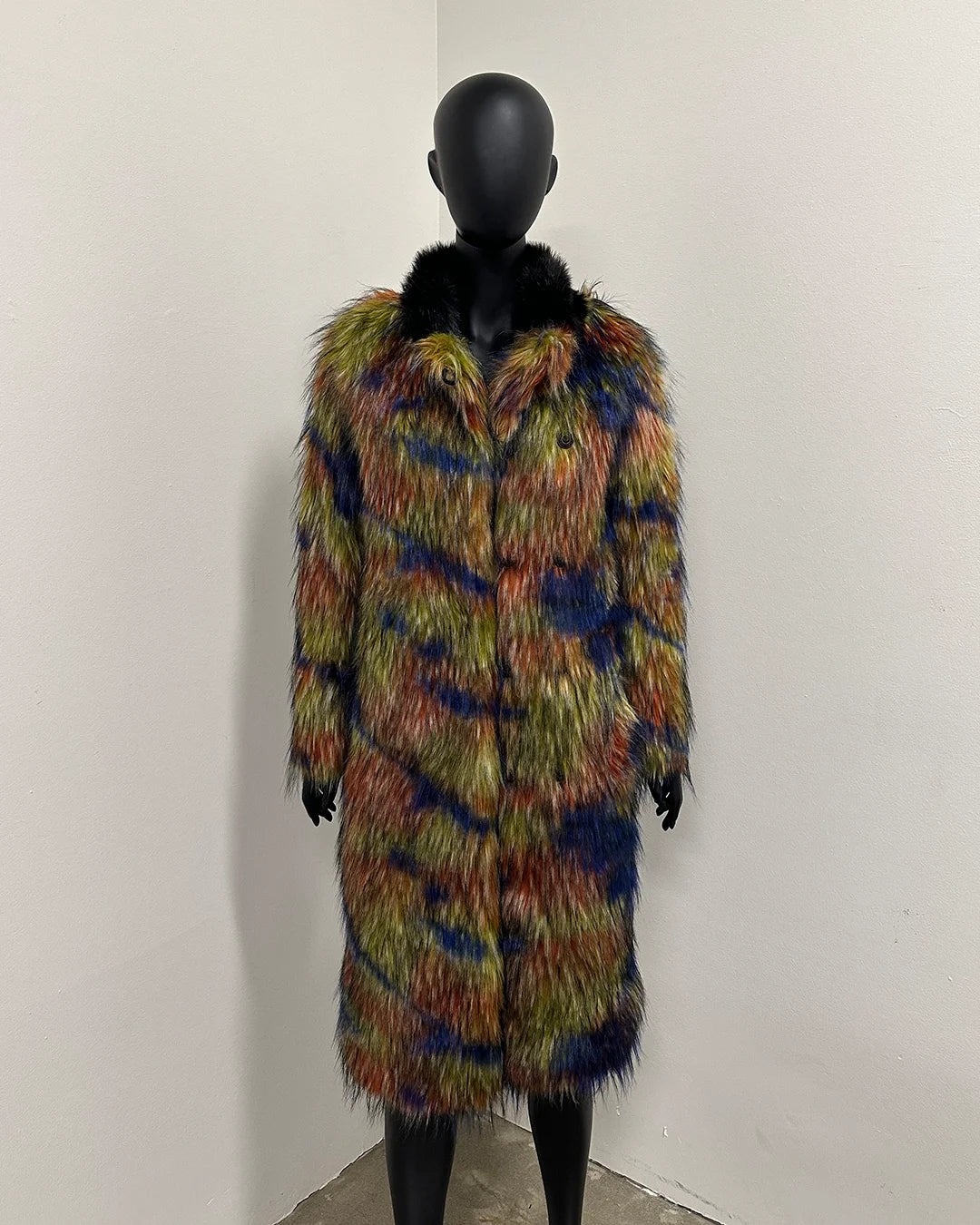 Multicolored fur coat on a mannequin against a white wall