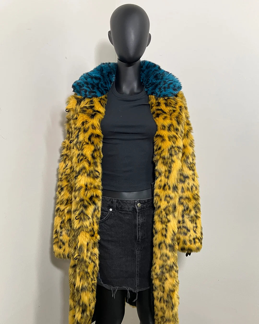 Mannequin wearing a yellow cheetah print coat with a blue cheetah print fake fur collar against a white background. SpiritHoods Online Sample Sale Style: Calf Length Faux Fur Coat in Yellow Cheetah size: MEDIUM