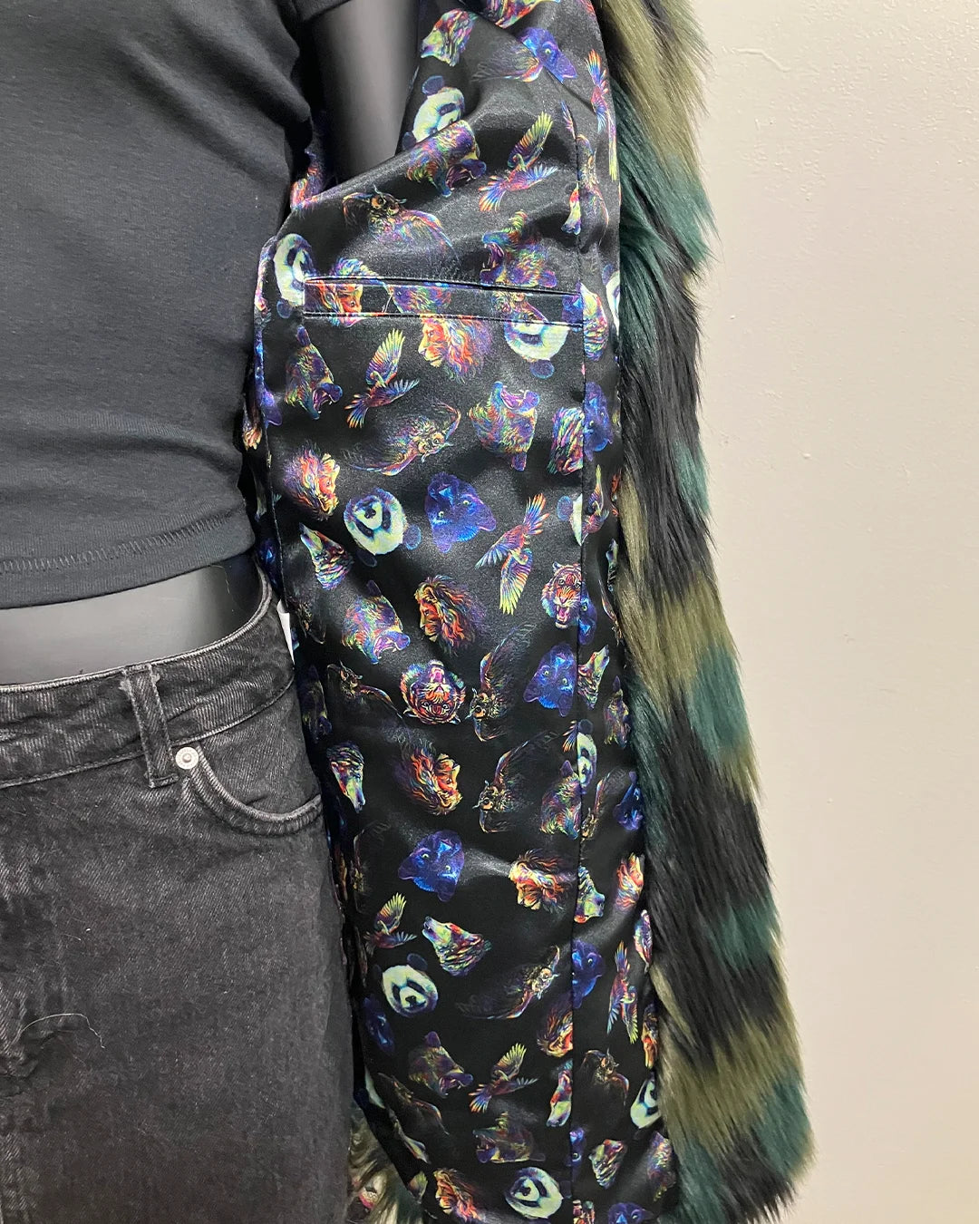 Colorful multi-animal faces with neon glow as the lining within the jacket