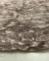 Close-up of a textured brown fabric pet bed cover on grey surface