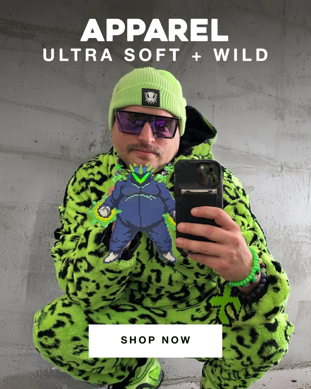 Man in bright green fuzzy streetwear posing against a concrete wall with a smartphone and pixel art patch, promoting bold and soft apparel.
