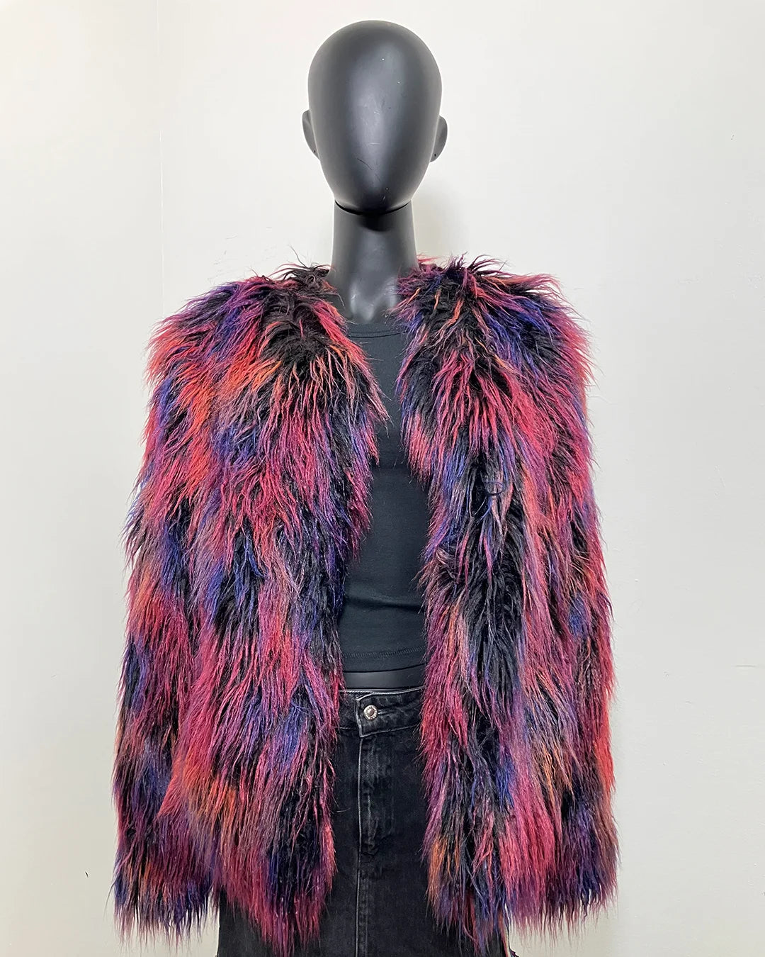 Multicolored fake fur long sleeved jacket on a mannequin against a white background