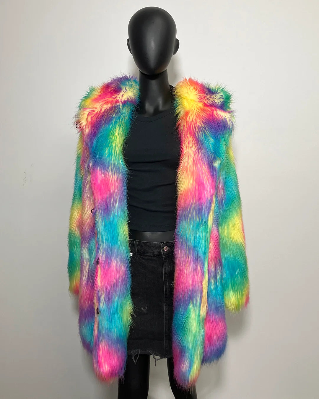Mannequin wearing a colorful fur vest against a plain background