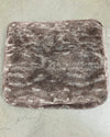 Textured brown pet bed cushion on a concrete floor