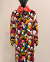 Multicolored fale fur coat with a vibrant pattern on a mannequin against a plain background