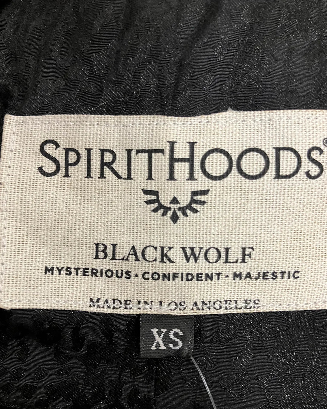 close-up photo of the Made in los Angeles Black Wolf Coat necklabel in XS sizing