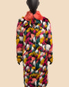Multicolored fake fur coat on a mannequin against a beige background