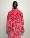 Mannequin wearing a bright pink coat with black leopard print pattern on a white background