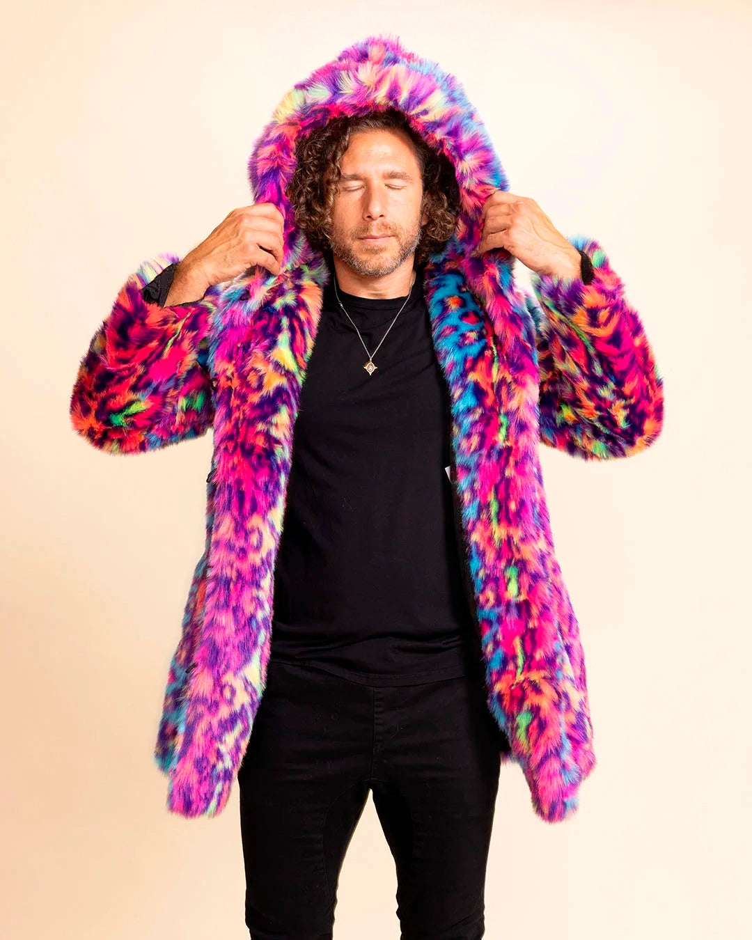 A Man wearing a colorful, neon patterned leopard print fake fur coat against a beige background. SpiritHoods 100% Fake Fur Jackets and Custom Made Faux Fur Coats 