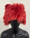 Red fluffy hat on a black mannequin 