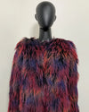 Multicolored fake fur jacket on a mannequin against a plain background