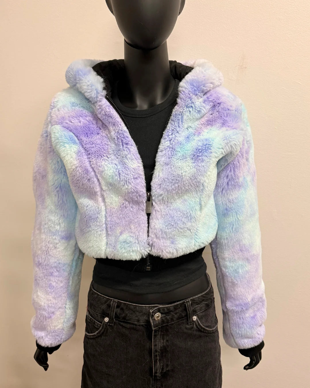 Pastel tie-dye hoodie on a mannequin against a beige background