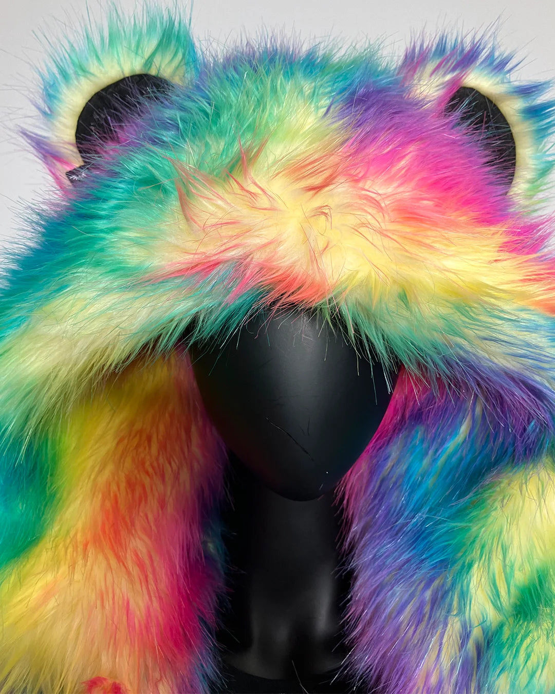 Multicolored fur coat on a mannequin against a gray background