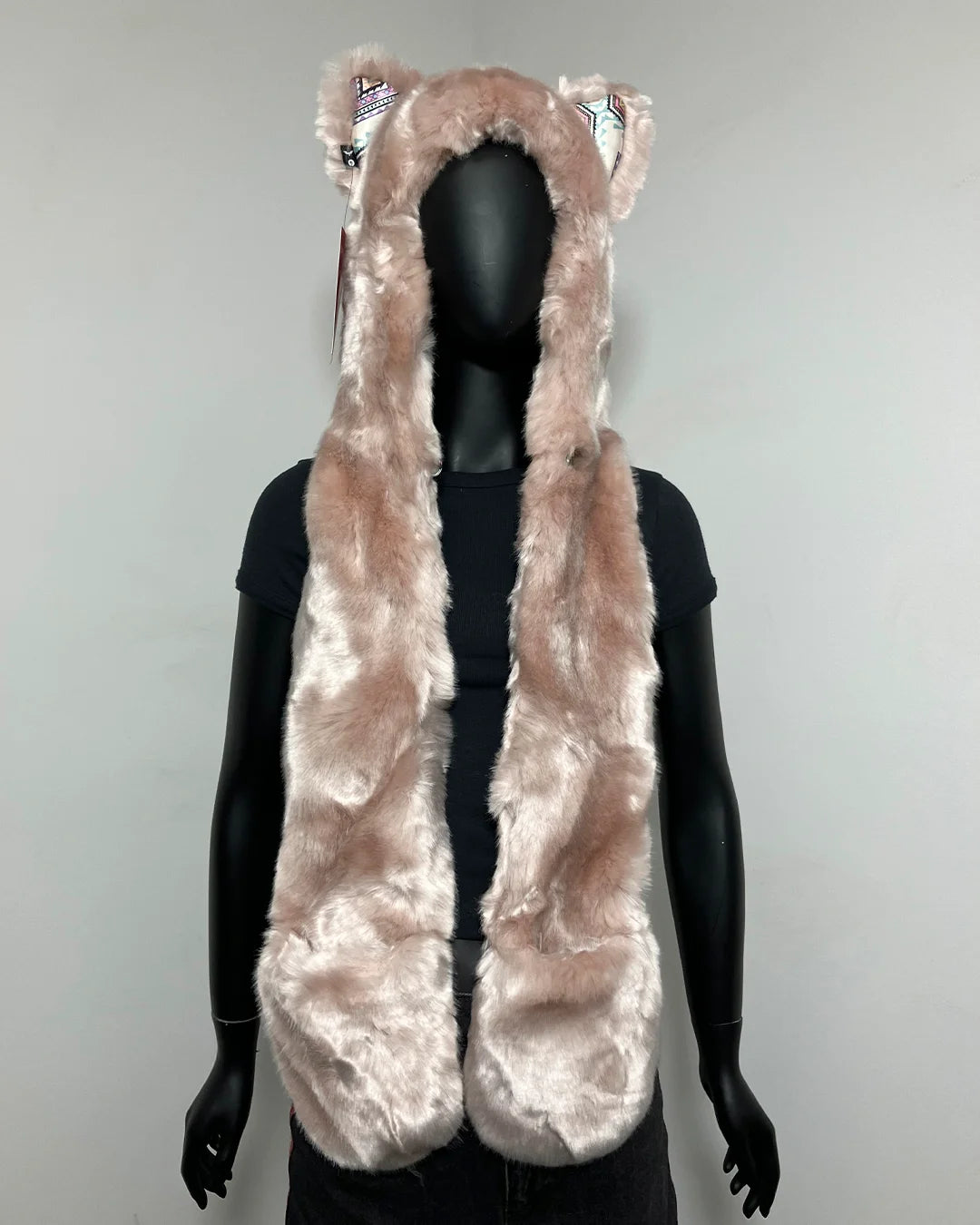 A plush faux-fur hooded vest or cape with cat-ear tufts, shown on a black mannequin against a plain light gray background.