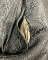 Close-up of torn inner left arm seam.